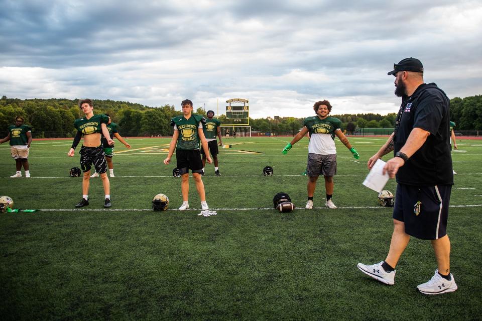 FDR head football coach Ken Barger talks to players as they stretch at warm up during football practice at FDR High School in Staatsburg, NY on Wednesday, August 24, 2022. KELLY MARSH/FOR THE POUGHKEEPSIE JOURNAL