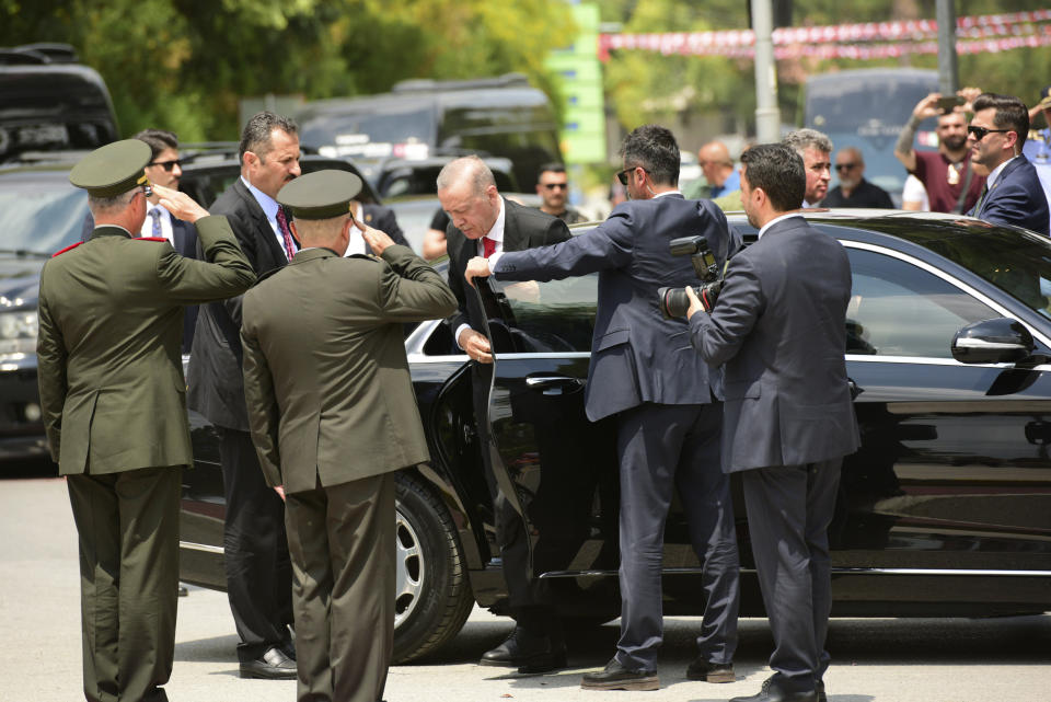 Turkish President Recep Tayyip Erdogan exits the car as he arrives in the Turkish occupied area of the divided capital Nicosia, Cyprus, Monday, June 12, 2023. Erdogan is in the Turkish occupied area of north part of the Cyprus island on his first trip after his re-election after the May 28 presidential election. (AP Photo/Nedim Enginsoy)