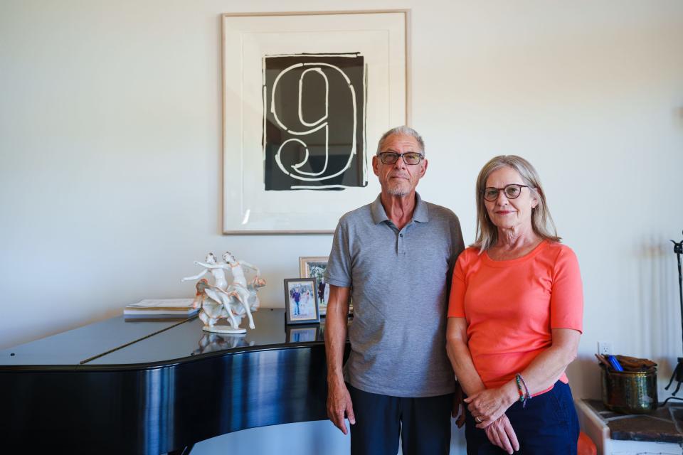 Bruce and Lisa Arlen pose for a photo in their home on Aug. 5, 2022, in Cave Creek. They stand in front of Jasper Johns' "Figure Nine" painting.