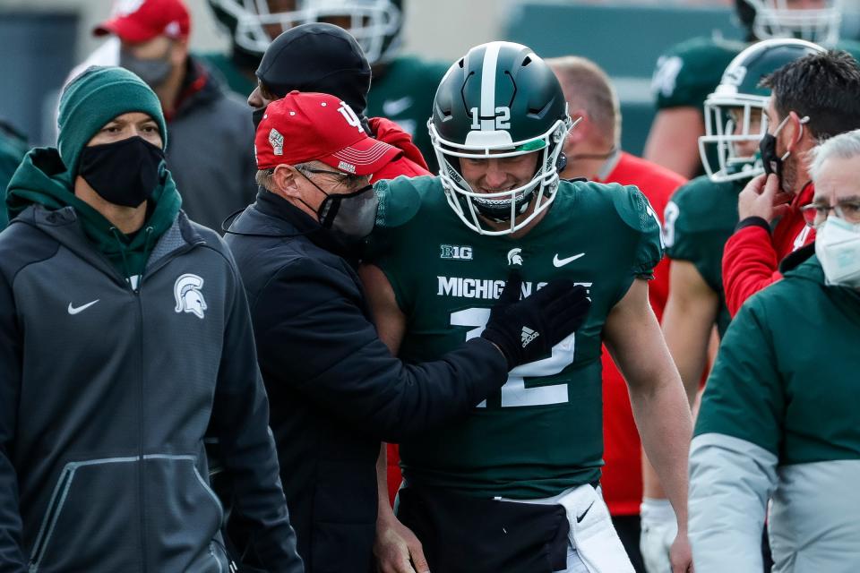 Indiana coach Tom Allen talks to Michigan State quarterback Rocky Lombardi after MSU's 24-0 loss to Indiana at Spartan Stadium on Saturday, Nov. 14, 2020.