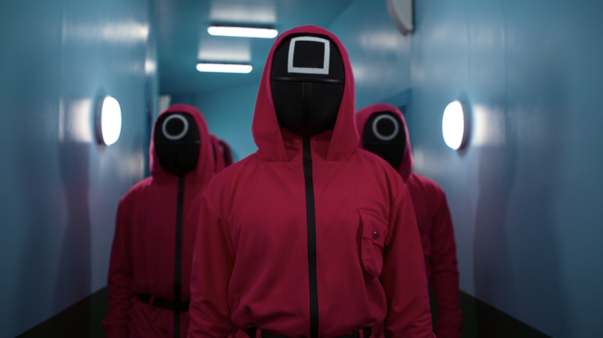  Squid Game: The Challenge participants wearing the masks from the Netflix series. 
