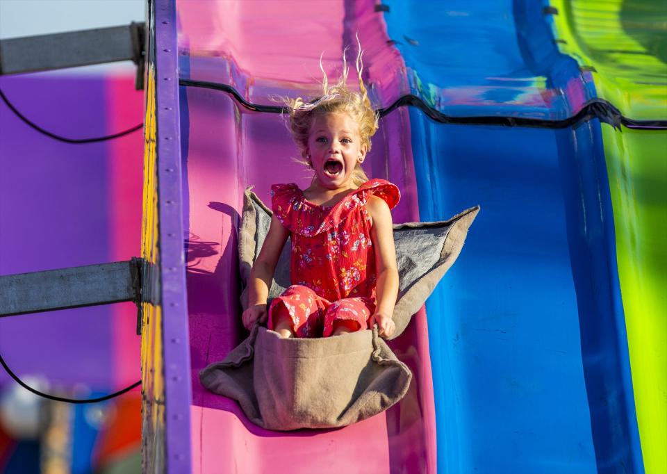 A young girl screams her way down the 'Fun Slide' in the Thrill Ville area of the 2019 Kentucky State Fair. Aug. 15, 2019