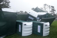 Fallen portable toilets are shown at Pebble Beach Golf Links before the scheduled final round of the AT&T Pebble Beach National Pro-Am golf tournament in Pebble Beach, Calif., Sunday, Feb. 4, 2024. The final round of the AT&T Pebble Beach Pro-Am has been postponed until Monday. (AP Photo/Ryan Sun)