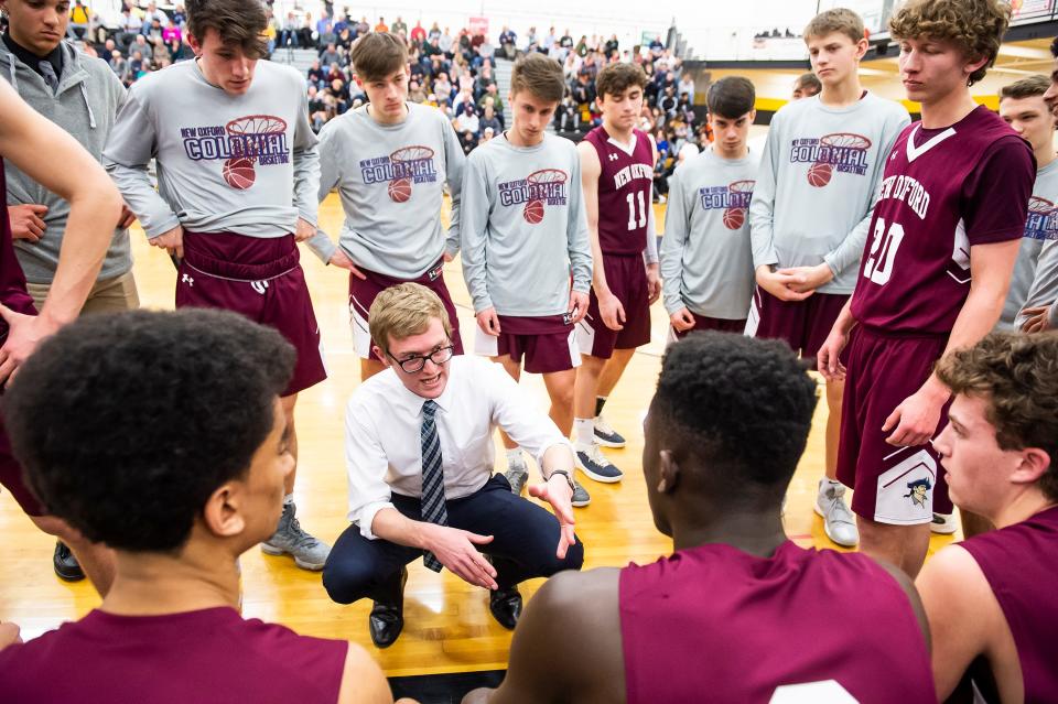 New Oxford head coach Sean Bair talks with his team before a playoff game against Eastern York in 2019. A freshman at the time, Tommy Haugh (far right) was a bench player for New Oxford.