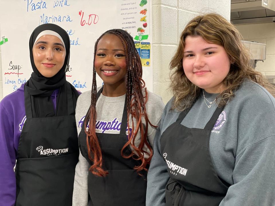Yakhin Abdulmoula,  Elizabeth Tontteh and Sarah Krahn, students in the Assumption College Catholic High School culinary program. The program teaches students how to cook, as well as food safety and handling skills and how to minimize waste while cooking. 