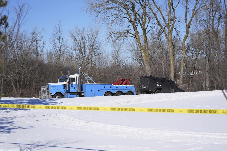 A police vehicle is towed near the scene where two police officers and a first responder were shot and killed, Sunday, Feb. 18, 2024, in Burnsville, Minn. (AP Photo/Abbie Parr)