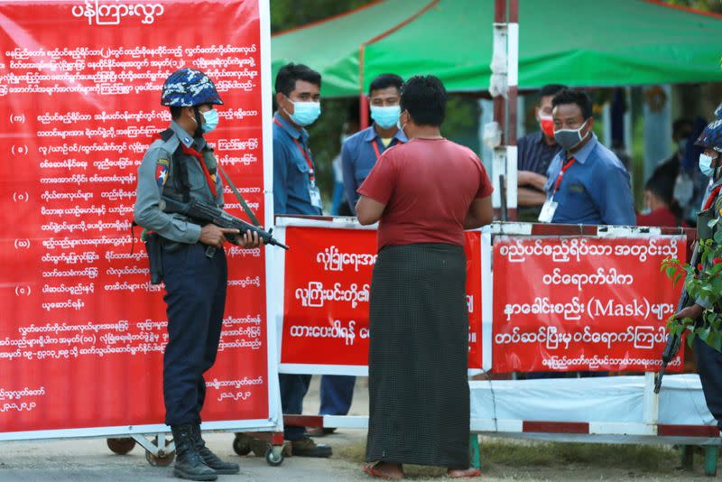 Myanmar's police officers stand guard at the entrance of parliament members residence at the congress compound in Naypyitaw