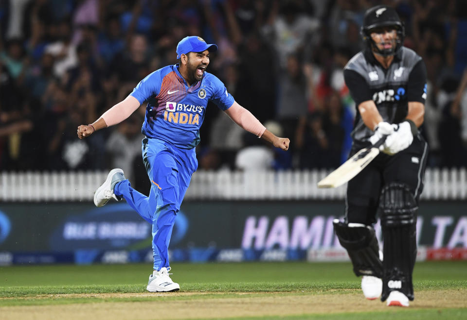 Rohit Sharma celebrates as New Zealand's Ross Taylor is bowled and the game is tied and goes to a super over. during the Twenty/20 cricket international between India and New Zealand in Hamilton, New Zealand, Wednesday, Jan. 29, 2020. (Andrew Cornaga/Photosport via AP)