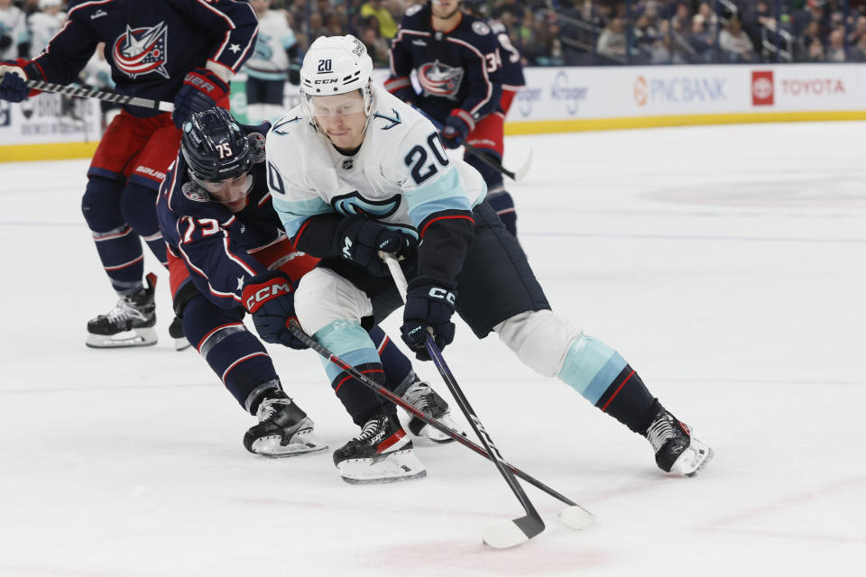 Columbus Blue Jackets' Tim Berni, left, and Seatte Kraken's Eeli Tolvanen reach for the puck during the first period of an NHL hockey game Friday, March 3, 2023, in Columbus, Ohio. (AP Photo/Jay LaPrete)
