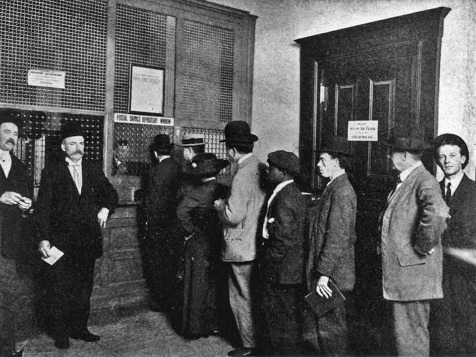 <span class="caption">Depositors stand in a queue at a postal savings window.</span> <span class="attribution"><a class="link " href="https://postalmuseum.si.edu/collections/object-spotlight/postal-savings-system" rel="nofollow noopener" target="_blank" data-ylk="slk:Smithsonian National Postal Museum;elm:context_link;itc:0;sec:content-canvas">Smithsonian National Postal Museum</a>, <a class="link " href="http://creativecommons.org/licenses/by/4.0/" rel="nofollow noopener" target="_blank" data-ylk="slk:CC BY;elm:context_link;itc:0;sec:content-canvas">CC BY</a></span>