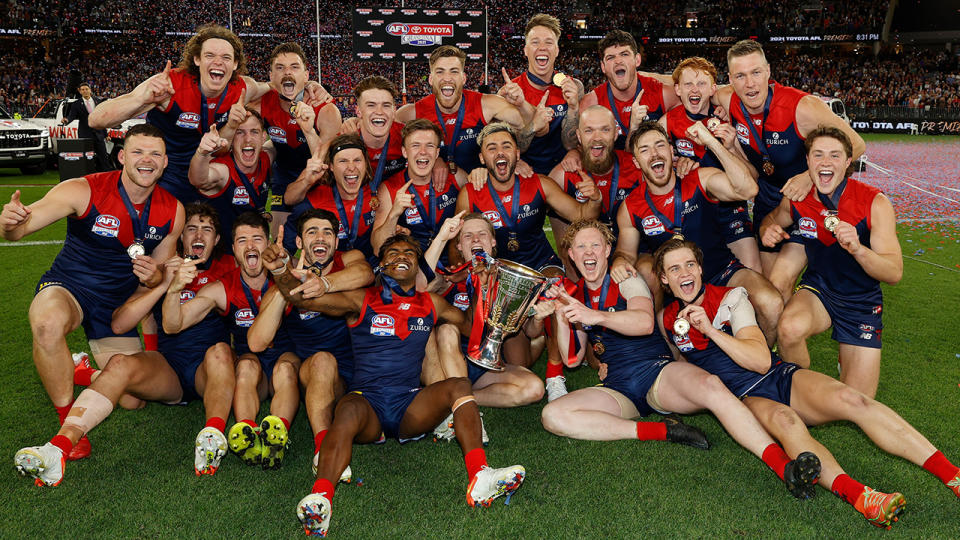 The Demons celebrate after defeating the Western Bulldogs to win the 2021 AFL grand final.