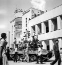 FILE - In this Aug. 19, 1953 file photo, a royalist tank moves into the courtyard of Tehran Radio a few minutes after pro-shah troops occupied the place during the coup which ousted Prime Minister Mohammad Mossadegh and his government. In 2018, as Iran deals with President Donald Trump's decision to pull America from the nuclear deal with world powers, more are invoking the 1953 CIA-backed coup that toppled Mossadegh as proof the U.S. cannot be trusted. (AP Photo, File)