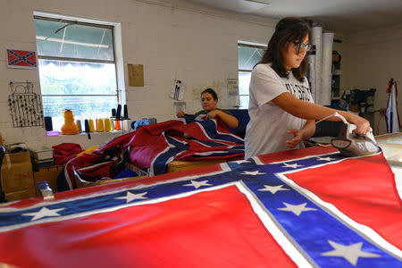 Cynthia Hernandez places stars on a Confederate Battle Flag in the Alabama Flag & Banner shop in Huntsville, Alabama, U.S., August 24, 2017. REUTERS/Harrison McClary