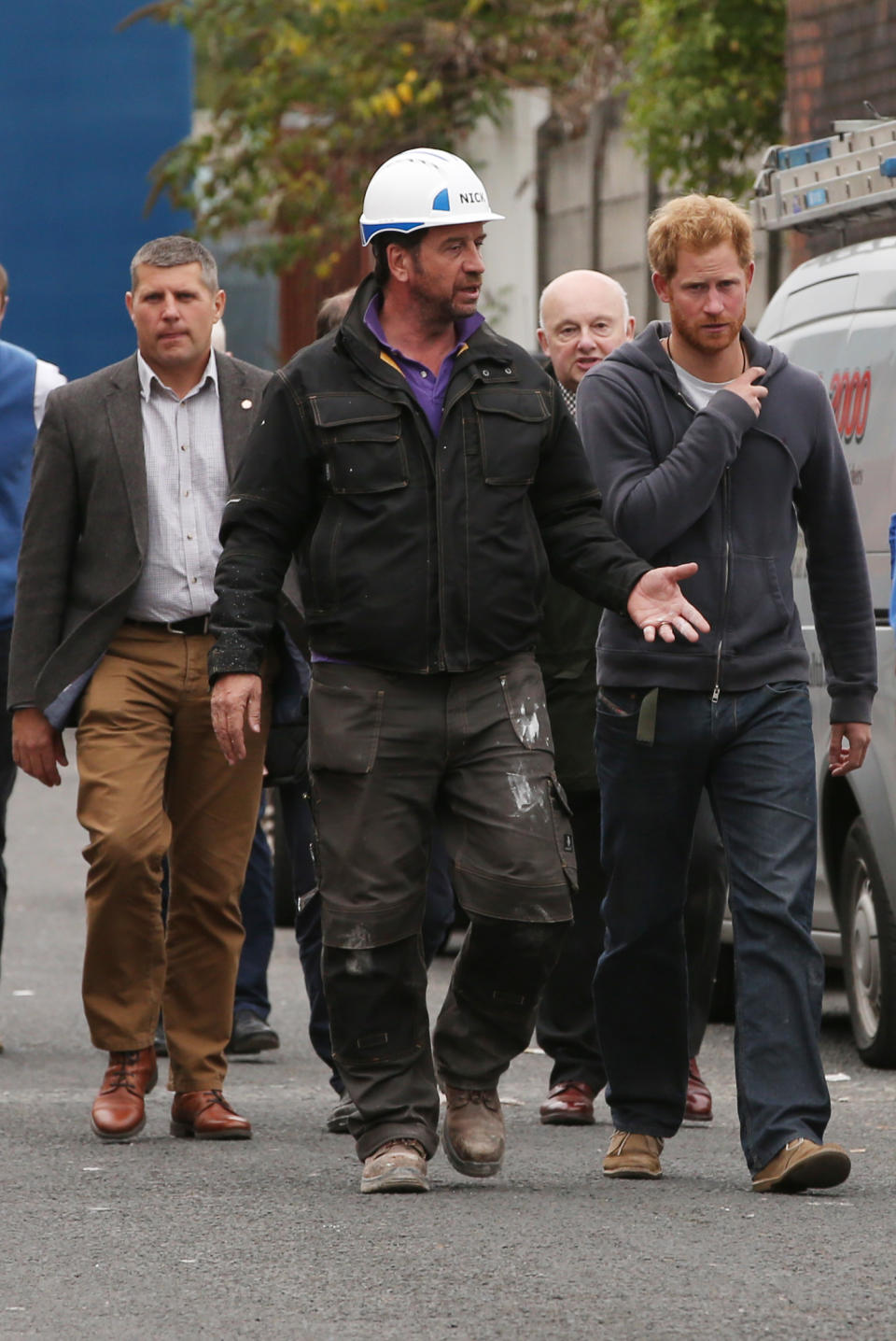 Prince Harry leaves with the show's host Nick Knowles after a visit to the BBC's DIY SOS Team for The Big Build: Veteran's Special at a street in Manchester.