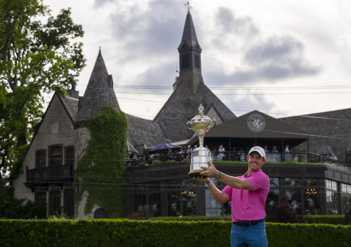 Rory McIlroy, of Northern Ireland, hoists the trophy after winning the Canadian Open golf tournament in Toronto on Sunday, June 12, 2022. (Frank Gunn/The Canadian Press via AP)