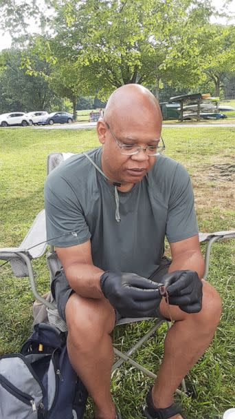 PHOTO: Frantz Dickerson hooks a fishing worm for one of his grandchildren.  (Courtesy Frantz Dickerson)