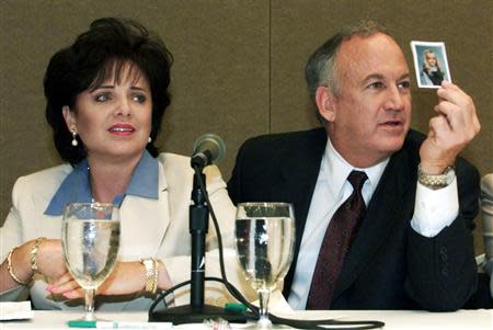 Patsy Ramsey and her husband, John Ramsey, produce a picture of JonBenet Ramsey during a press conference where they released the results of an independant lie detector test in Atlanta in this May 24, 2000 file photo. REUTERS/Tami Chappell/ Files