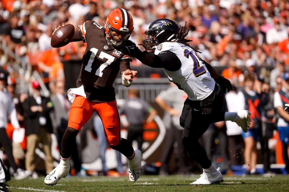 Browns quarterback Dorian Thompson-Robinson eludes Baltimore Ravens outside linebacker Jadeveon Clowney, Sunday, Oct. 1, 2023, in Cleveland.