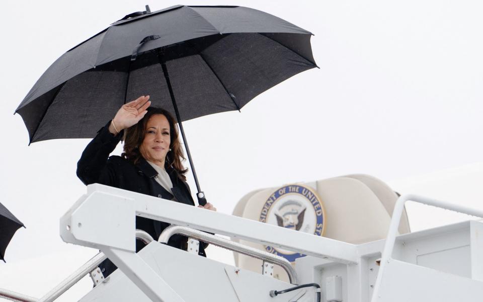 Kamala Harris waves as she boards Air Force Two