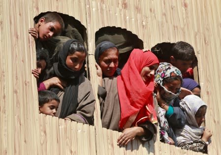 Kashmir women and children react as they watch the body of Nasir Ahmad, a suspected separatist militant, during his funeral procession after he was killed in a gun battle with Indian soldiers, in Arwani village