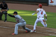 Detroit Tigers' C.J. Cron (26) fields the ball as Cincinnati Reds' Shogo Akiyama (4) is out at first base in the fourth inning during a baseball game at Great American Ballpark in Cincinnati, Saturday, July 25, 2020. (AP Photo/Aaron Doster)