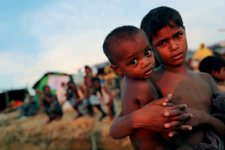 FILE PHOTO: Rohingya refugee children look on at a refugee camp in Palang Khali near Cox's Bazar, Bangladesh, October 4, 2017. REUTERS/Mohammad Ponir Hossain/File Photo