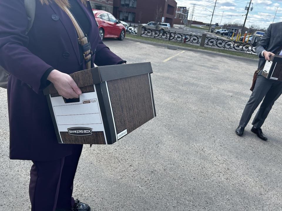 Lawyers handed over two Bankers boxes of documents Thursday, containing the record of everything Minister of Education Bill Hogan relied on when deciding how to change Policy 713 last year.