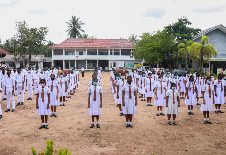 Students attending morning assemblies wear face masks after their schools were reopened in Panadura, Sri Lanka, on July 6. The government announced all schools would reopen for students in grades 5, 11 and 13 after they were closed in March due to the coronavirus pandemic.