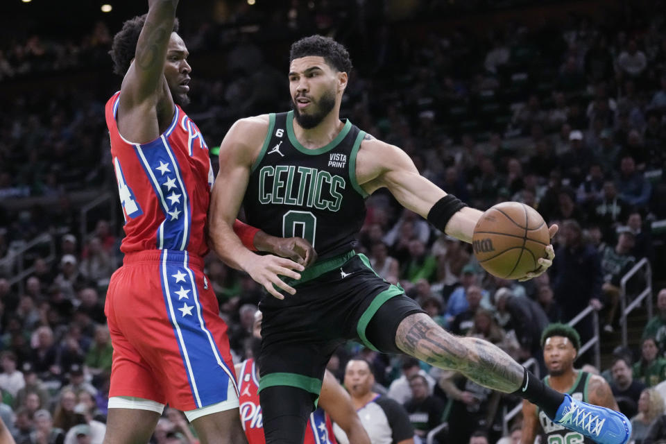 Boston Celtics forward Jayson Tatum (0) is pressured by Philadelphia 76ers forward Paul Reed (44) during the first half of Game 1 in the NBA basketball Eastern Conference semifinals playoff series, Monday, May 1, 2023, in Boston. (AP Photo/Charles Krupa)