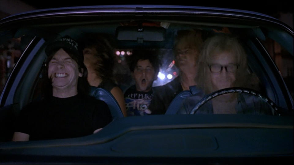 <p>The defining moment of Wayne’s World and another scene that forever changed a classic rock tune for an entire generation: every time this song is played, look around the room and see how many people start rocking their heads when the Brian May riff kicks in. Iconic. (Credit: Paramount Pictures) </p>