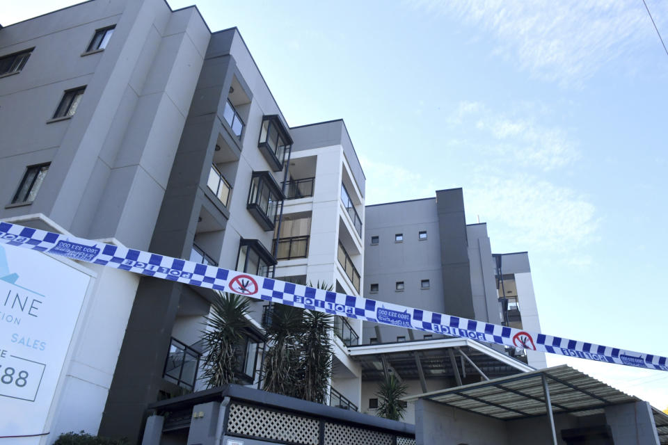 Police tape is seen at a lock downed apartment building at Devitt Street in the south western suburb of Blacktown in Sydney, Wednesday, July 28, 2021. Australia’s largest city Sydney will remain in lockdown for another four weeks due to a growing COVID-19 cluster. (Mick Tsikas/AAP Image via AP)