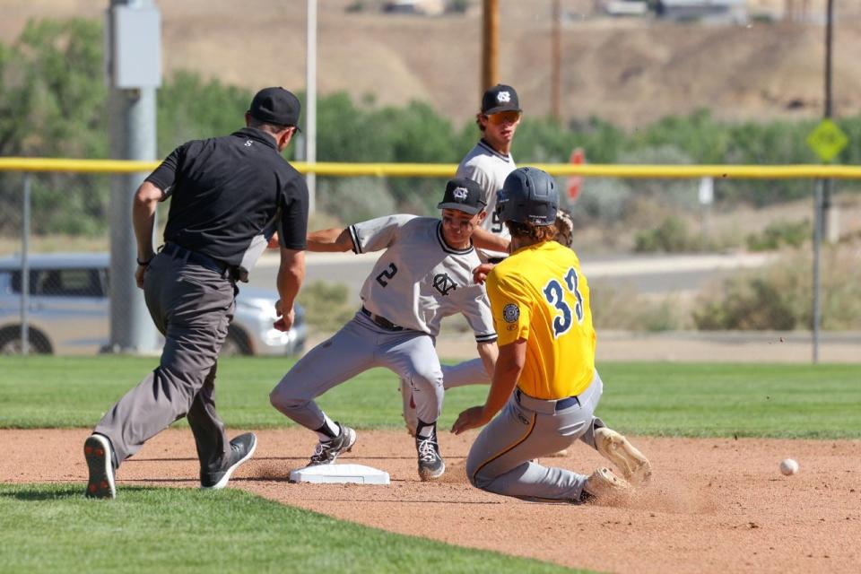 Midland Baseball's Riley Nelson avoids the tag and safely slides into second base in the top of the second inning during pool play action of the Connie Mack World Series on Saturday, July 23, 2022 at the Sports Complex.