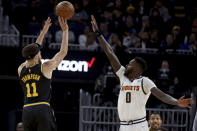 Golden State Warriors guard Klay Thompson (11) shoots against Denver Nuggets forward JaMychal Green (0) during the first half of Game 5 of an NBA basketball first-round playoff series in San Francisco, Wednesday, April 27, 2022. (AP Photo/Jed Jacobsohn)