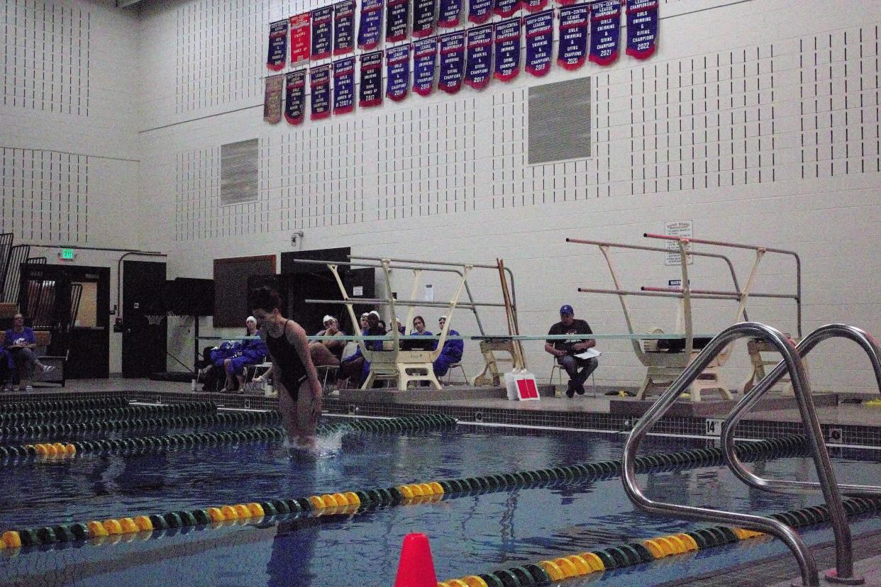 Pueblo Central High School senior diver Molly Charles completes a dive against Pueblo County on Dec. 13 at Pueblo County High School.