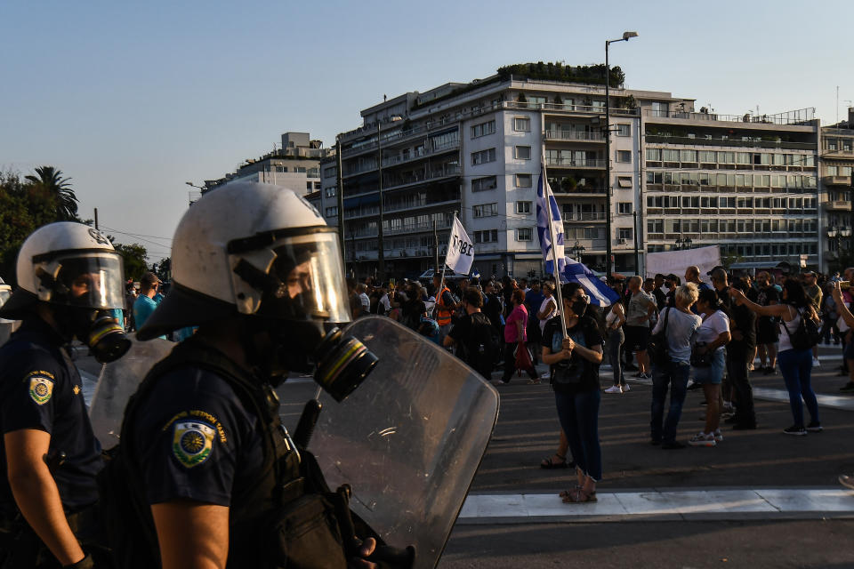 ATHENS, GREECE - JULY 24: Anti-vaccine protesters hold a banners and wave flags as they march to the parliament, in Athens, on Saturday, July 24, 2021. Thousands of people protested against Greek government's measures to curb rising COVID-19 infections. (Photo by Dimitris Lampropoulos/Anadolu Agency via Getty Images)