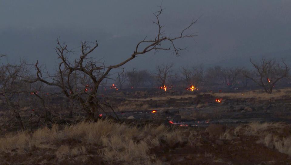 Flames from a wildfire burn in Kihei, Hawaii Wednesday, Aug. 9, 2023. Thousands of residents raced to escape homes on Maui as blazes swept across the island, destroying parts of a centuries-old town in one of the deadliest U.S. wildfires in recent years.