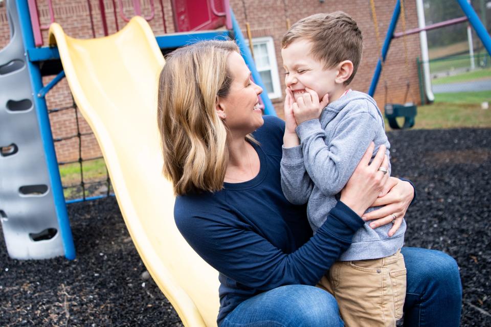 Cortney Piper and her son Aidan Armstrong giggle while sharing kisses at the Riverside Baptist Church playground in Knoxville on Thursday, March 23, 2023. 