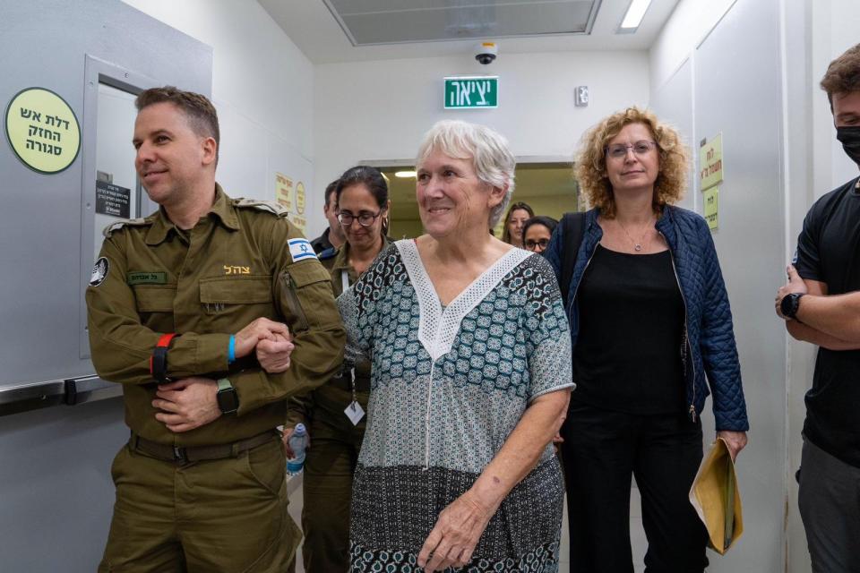 Margalit Mozes being supported by an Israeli soldier after her release