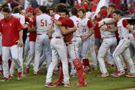 North Carolina State players Evan Justice (34) and Luca Tresh (24) hug following their 3-2 win over Arkansas during an NCAA college baseball super regional game Sunday, June 13, 2021, in Fayetteville, Ark. (AP Photo/Michael Woods)