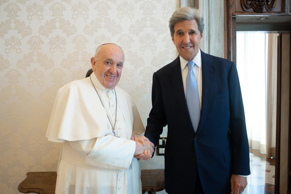 Pope Francis and John Kerry, right, shake hands as they pose for a photo at the Vatican, Saturday, May 15, 2021. Former U.S. Secretary of State John Kerry, currently President Biden’s envoy on the climate, met in private audience with Pope Francis on Saturday, afterward calling the pope “a compelling moral authority on the subject of the climate crisis” who has been “ahead of the curve.” Kerry told Vatican News in an interview that the pope speaks with “unique authority, compelling moral authority, that hopefull can push people to greater ambition to get the job done. (Vatican Media via AP)