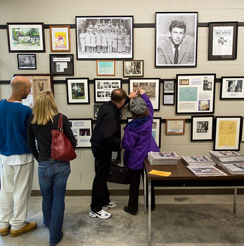 This December 2009 photo supplied by the Surry Arts Council shows visitors looking at exhibits in the Andy Griffith Museum in Mount Airy, N.C. Mount Airy served as the inspiration for Mayberry, which was the fictional setting for the popular 1960s TV show “The Andy Griffith Show.” Tourism is up in Mount Airy since Griffith’s July 3 death, with 10,400 people visiting the museum in July, nearly twice the number who visited in July 2011. (AP Photo/Surry Arts Council, Hobart Jones)