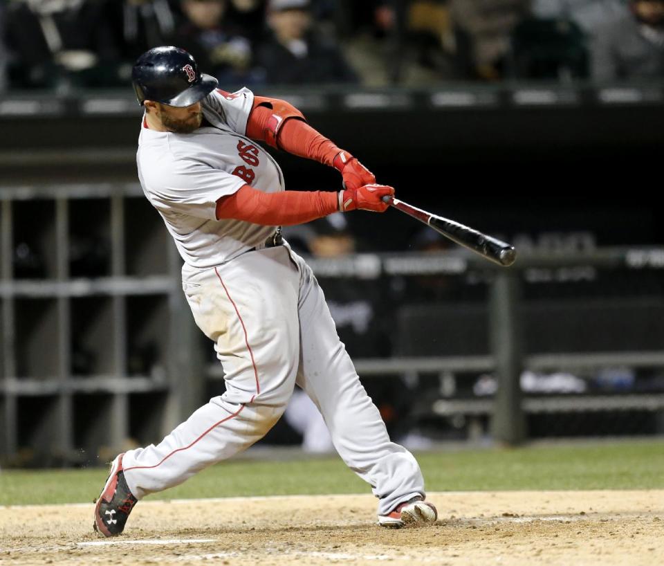 Boston Red Sox's Jonny Gomes hits a sacrifice fly off a pitch by Chicago White Sox relief pitcher Daniel Webb, scoring Dustin Pedroia, during the 11th inning of a baseball game Wednesday, April 16, 2014, in Chicago. (AP Photo/Charles Rex Arbogast)