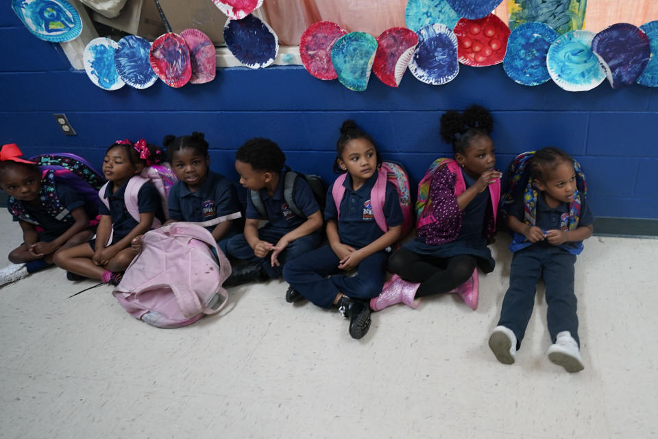 Children wait for dismissal at Schaumburg Elementary, part of the ReNEW charter network, in New Orleans, Wednesday, April 19, 2023. (AP Photo/Gerald Herbert)
