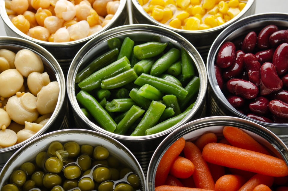 A close up of several canned foods, including green beans, carrots, red kidney beans, mushrooms, chickpeas, corn and peas. (Photo via Getty Images)