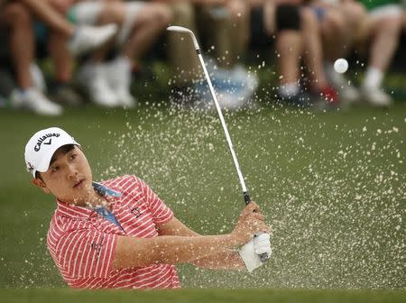 Bae-Sang-Moon of South Korea hits from a sand trap to the 18th green during second round play of the Masters golf tournament at the Augusta National Golf Course in Augusta, Georgia April 10, 2015. REUTERS/Jim Young