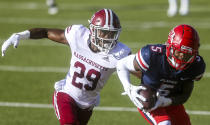 Liberty wide receiver DJ Stubbs (5) hauls in a pass as he is defended by Massachusetts player Cody Jones (29) during the first half of an NCAA college football game on Friday, Nov. 27, 2020, at Williams Stadium in Lynchburg, Va. (AP Photo/Shaban Athuman)