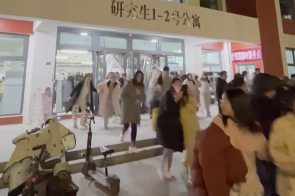 In this photo provided by Wang Xi, students evacuate from their dormitory at the Lanzhou University Yuzhong campus in Lanzhou in northwestern China's Gansu province Tuesday, Dec. 19, 2023, after an earthquake hit the area. At least 100 were killed in a magnitude 6.2 earthquake in northwestern China, the country's state media reported on Tuesday. (Wang Xi via AP)