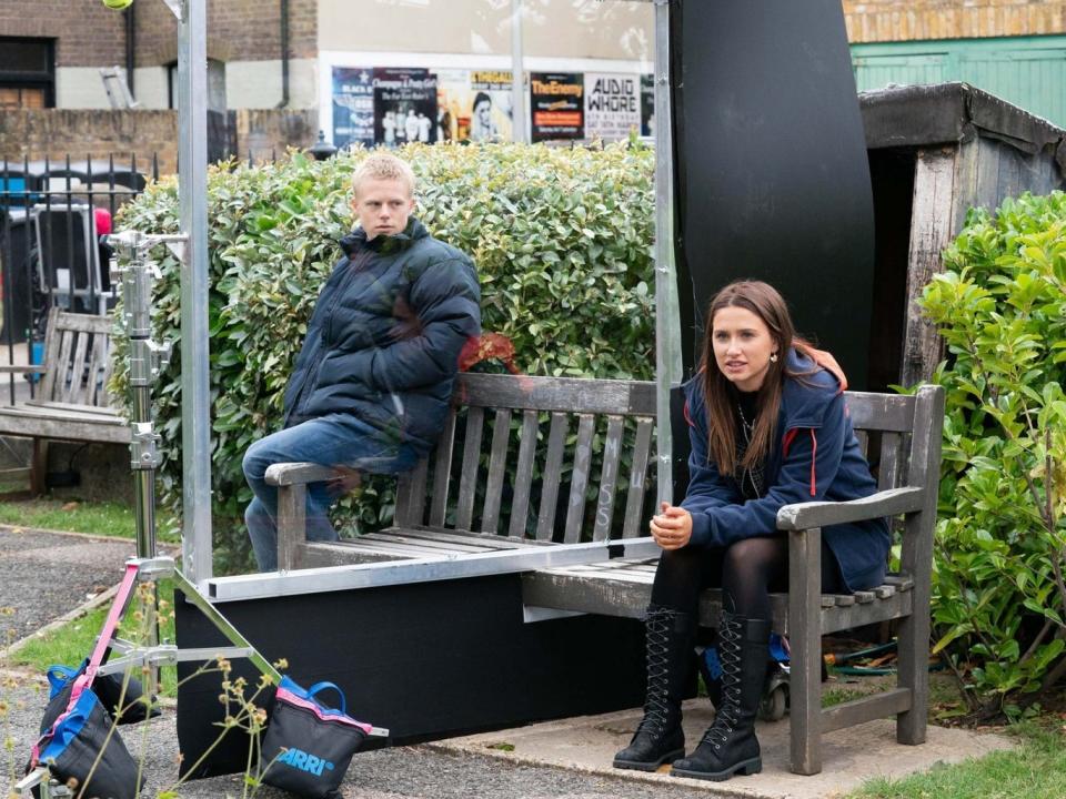 The cast of EastEnders film through a perspex screenBBC