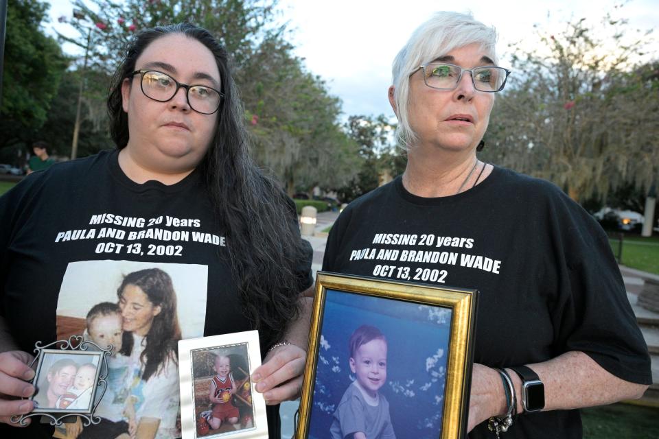 Mary Ramsbottom, right, and her daughter Tara Ramsbottom hold portraits Paula and Brandon Wade. Today, the mother and son would be 45 and 23 years old.