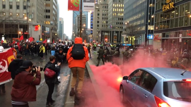 Smoke bombs, smashed windows, 1 arrest at Montreal anti-capitalist march